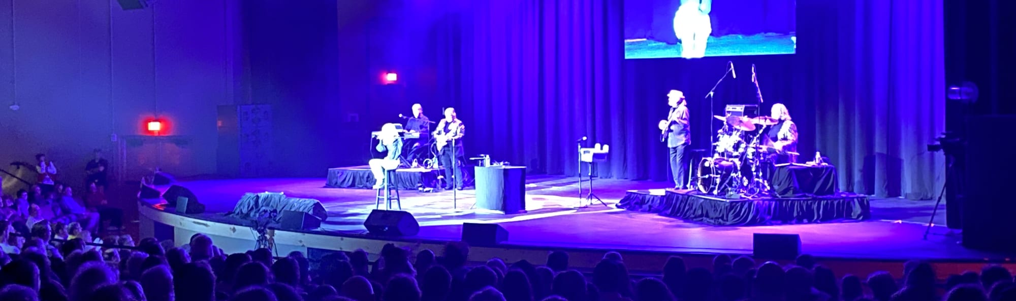 signer on stage in chair washed out by the lights Palm Springs